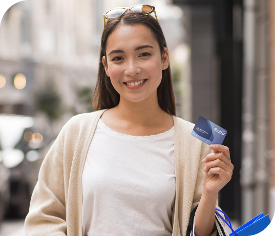 smiley woman outdoors holding shopping bags credit card Eucard